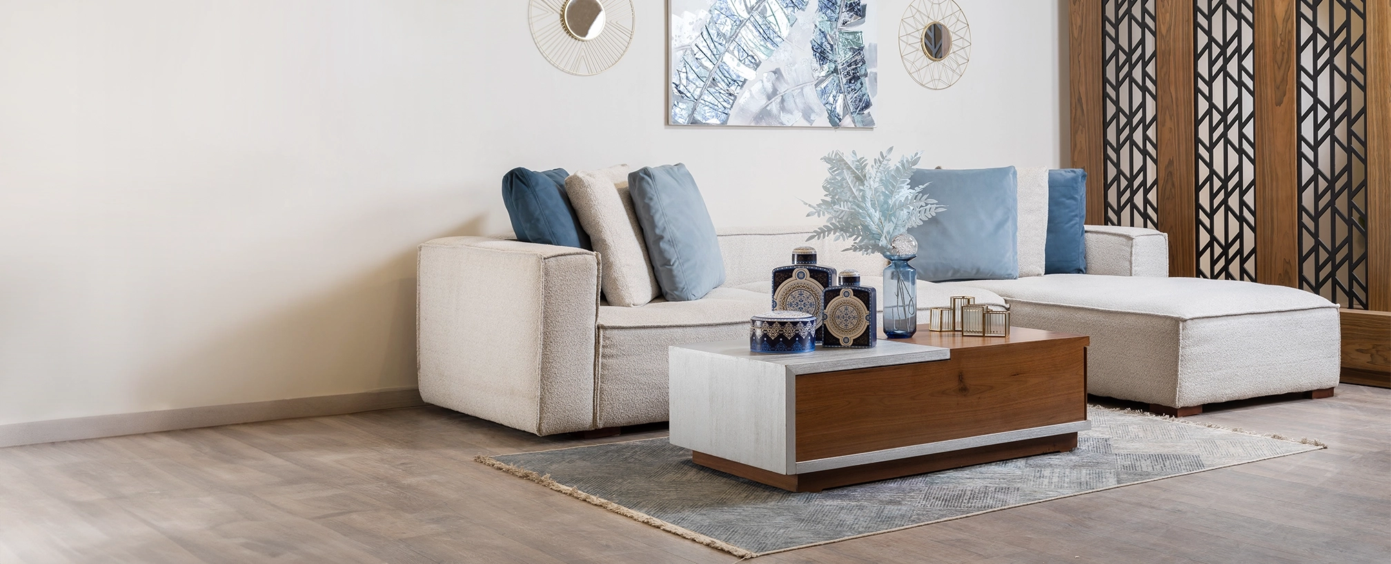 A woman in white sitting on a couch in a modern living room with a window and a plant, interior by Cube